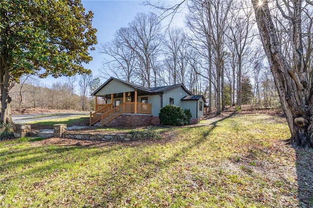 view of property exterior featuring a porch and a yard