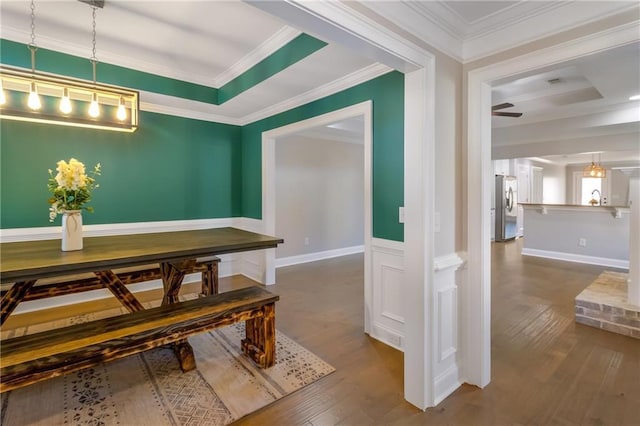 dining area with hardwood / wood-style floors and crown molding