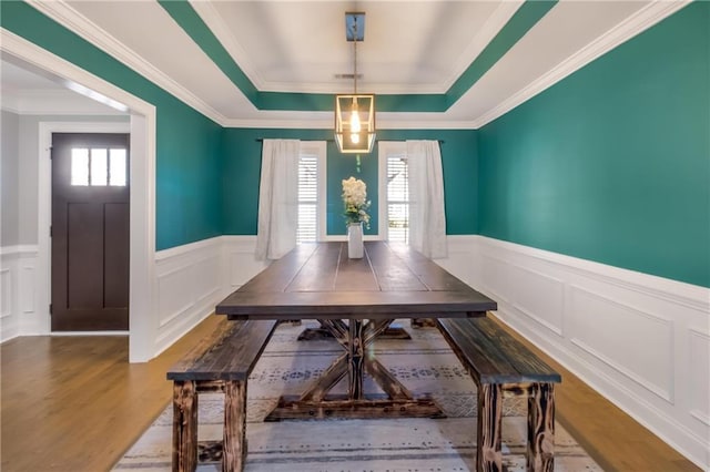 dining room featuring hardwood / wood-style floors, crown molding, and plenty of natural light