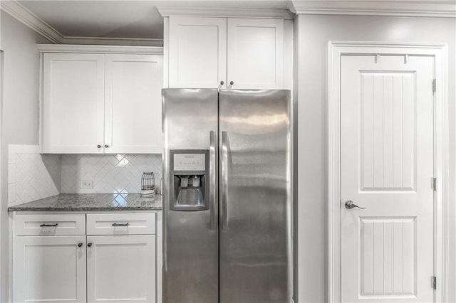 kitchen featuring backsplash, stainless steel fridge, ornamental molding, and white cabinets