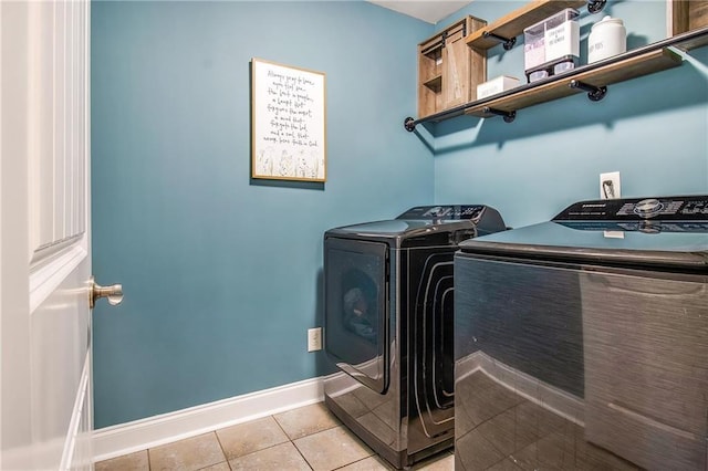 laundry area featuring light tile patterned flooring and washer and clothes dryer