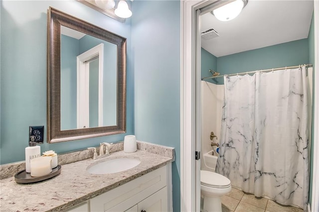 full bathroom with tile patterned floors, toilet, vanity, and shower / bath combo