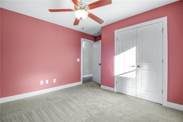 unfurnished bedroom featuring light colored carpet, ceiling fan, and a closet