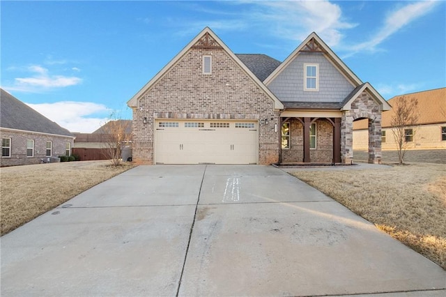 view of front of property featuring a garage and a front lawn