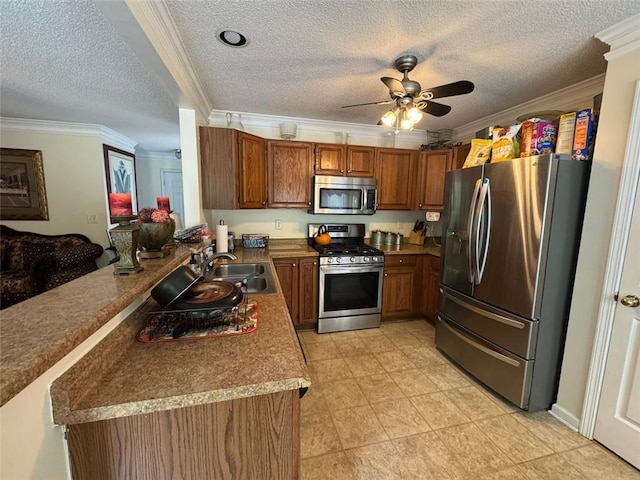 2246 Carrington Dr, Ellenwood, GA 30294 - kitchen with brown cabinetry, ornamental molding, appliances with stainless steel finishes, and a textured ceiling