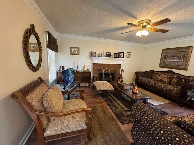 2246 Carrington Dr, Ellenwood, GA 30294 - living area featuring a ceiling fan, ornamental molding, wood finished floors, and a fireplace