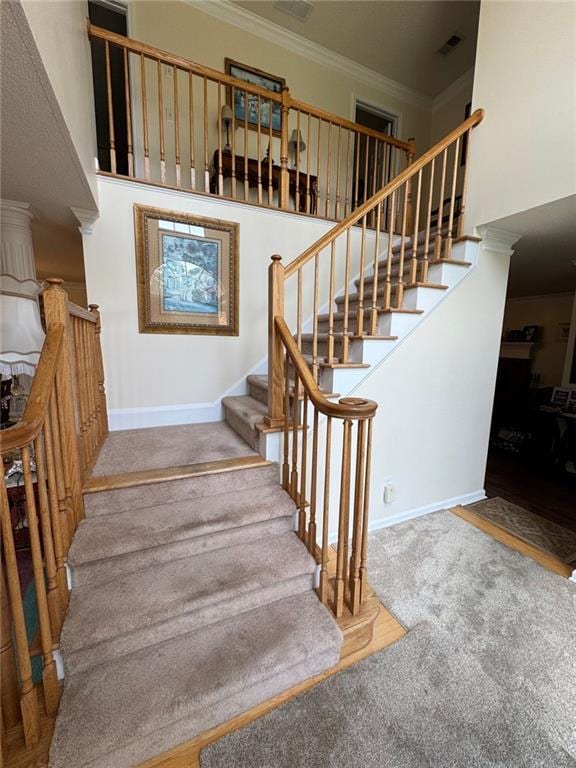 2246 Carrington Dr, Ellenwood, GA 30294 - stairs with a high ceiling, crown molding, visible vents, and carpet floors