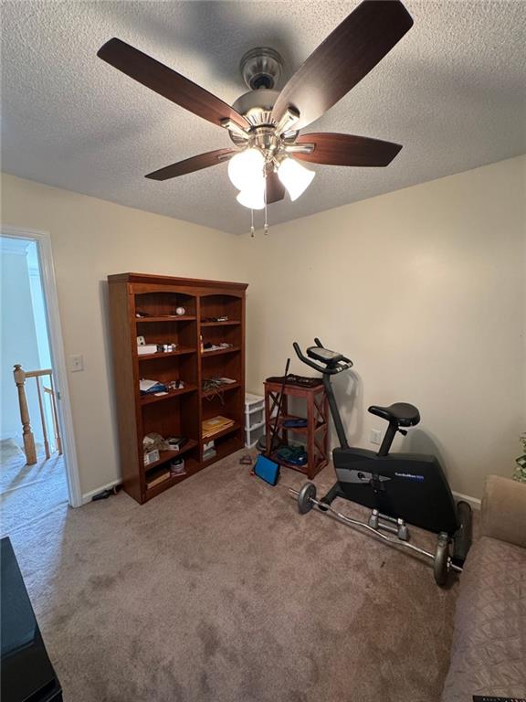 2246 Carrington Dr, Ellenwood, GA 30294 - exercise area with carpet, a textured ceiling, and a ceiling fan