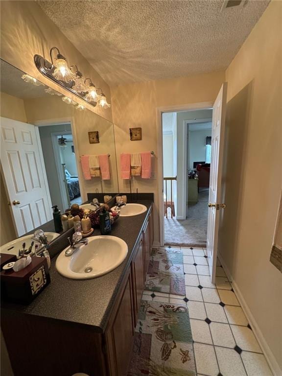 2246 Carrington Dr, Ellenwood, GA 30294 - full bath with a sink, a textured ceiling, and double vanity