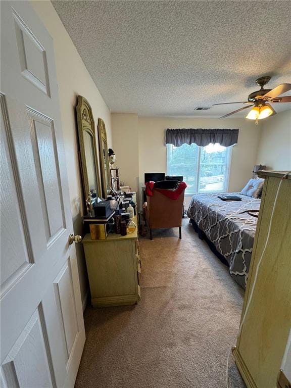 2246 Carrington Dr, Ellenwood, GA 30294 - bedroom with a ceiling fan, visible vents, carpet floors, and a textured ceiling