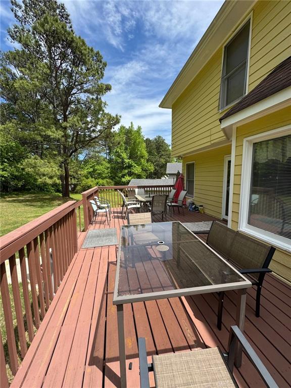 2246 Carrington Dr, Ellenwood, GA 30294 - wooden terrace featuring outdoor dining area