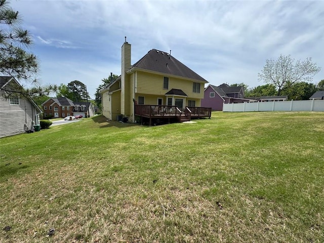 2246 Carrington Dr, Ellenwood, GA 30294 - rear view of property with fence, a wooden deck, a chimney, and a yard