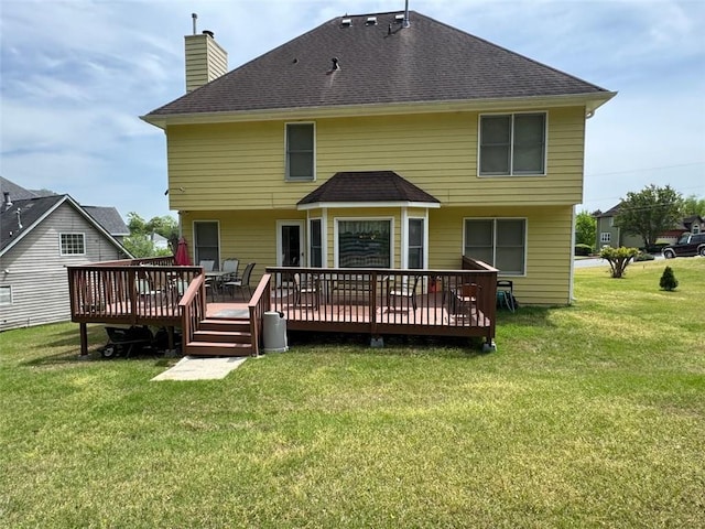 2246 Carrington Dr, Ellenwood, GA 30294 - rear view of house with a chimney, a wooden deck, a yard, and a shingled roof