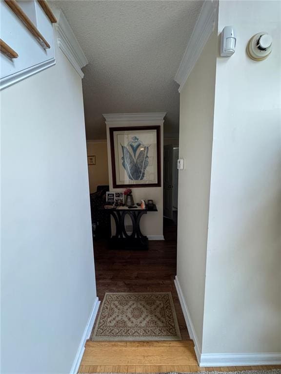2246 Carrington Dr, Ellenwood, GA 30294 - corridor featuring wood finished floors, a textured ceiling, baseboards, and ornamental molding