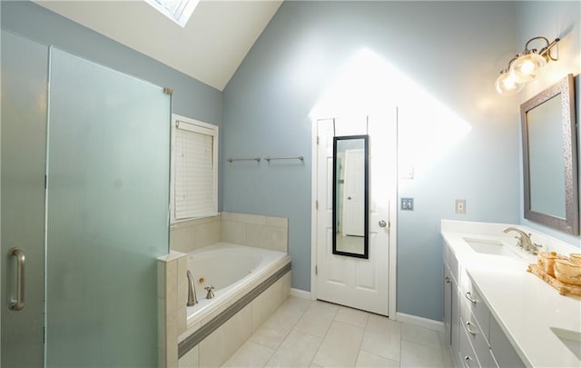 bathroom featuring tile patterned flooring, vanity, lofted ceiling with skylight, and independent shower and bath