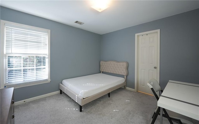 bedroom featuring light carpet