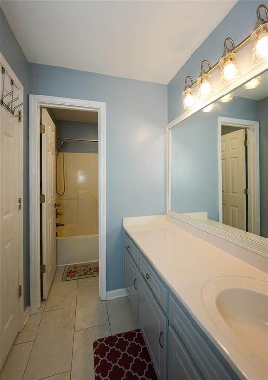 bathroom with tile patterned flooring, vanity, and washtub / shower combination