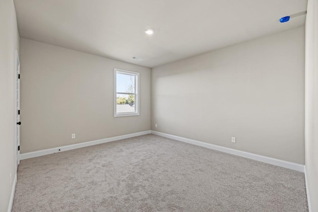 carpeted spare room featuring recessed lighting, visible vents, and baseboards