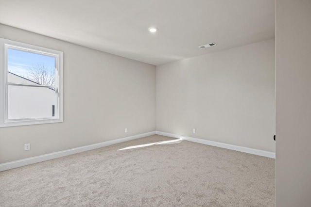 spare room featuring recessed lighting, carpet flooring, baseboards, and visible vents