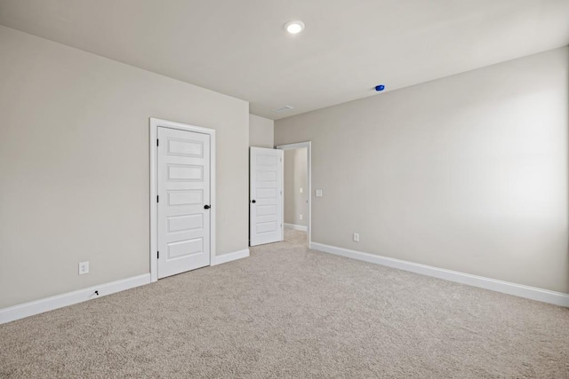 unfurnished bedroom featuring recessed lighting, baseboards, and light colored carpet