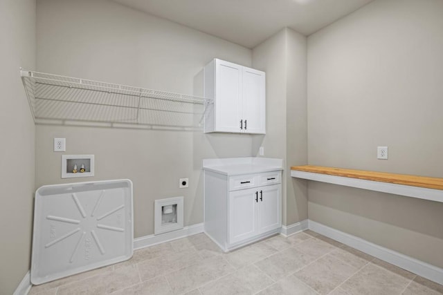 washroom with cabinet space, electric dryer hookup, baseboards, and washer hookup