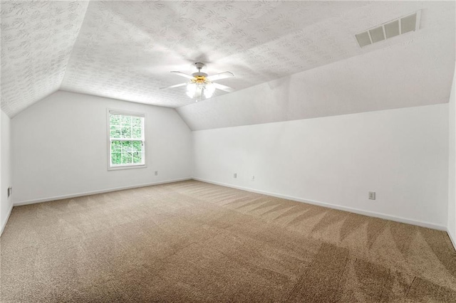 8770 Amberfield Dr, Gainesville, GA 30506 - additional living space with lofted ceiling, ceiling fan, carpet flooring, baseboards, and a textured ceiling