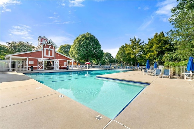 8770 Amberfield Dr, Gainesville, GA 30506 - community pool with a barn, a patio area, and view of wooded area