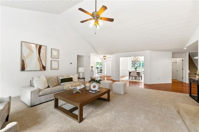 8770 Amberfield Dr, Gainesville, GA 30506 - carpeted living room with ceiling fan, high vaulted ceiling, baseboards, and stairs