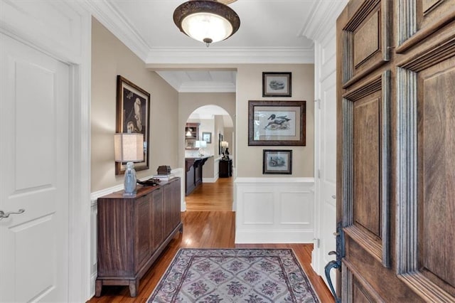 hall featuring wood-type flooring and ornamental molding