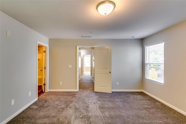 unfurnished room featuring carpet