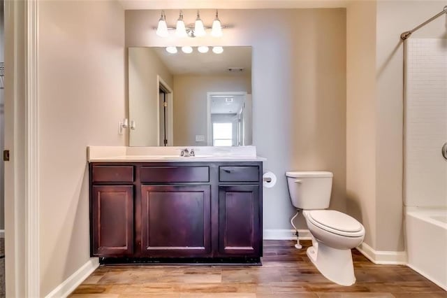 full bathroom with vanity, hardwood / wood-style flooring, toilet, and bathing tub / shower combination