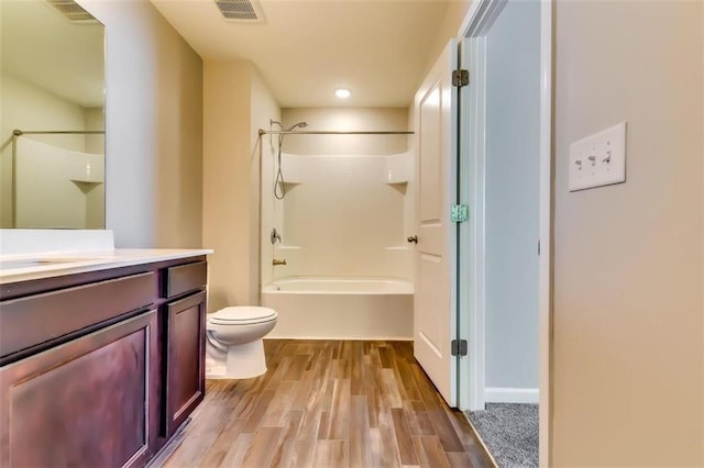 full bathroom with vanity, hardwood / wood-style floors, shower / washtub combination, and toilet