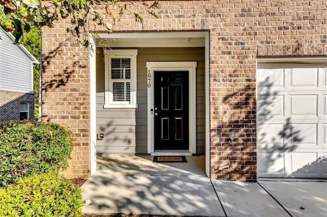 doorway to property with a garage