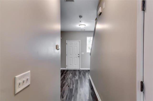 corridor with dark hardwood / wood-style flooring