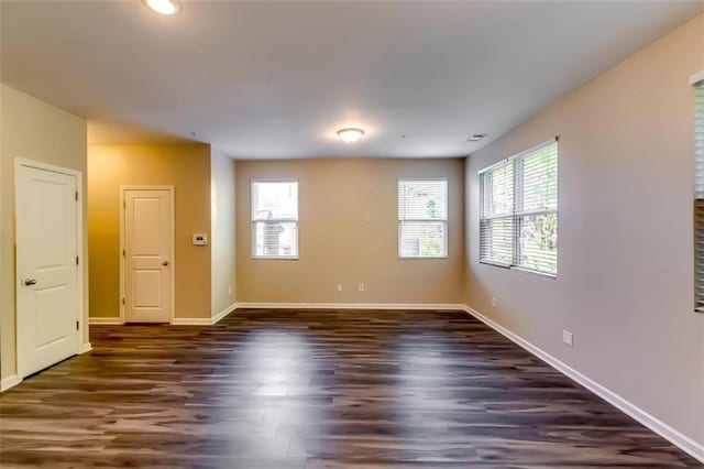 spare room featuring dark hardwood / wood-style flooring