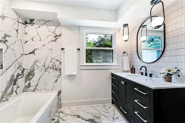 full bathroom featuring marble finish floor, shower / tub combination, baseboards, and vanity