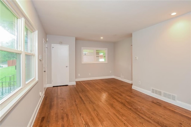 empty room with hardwood / wood-style floors