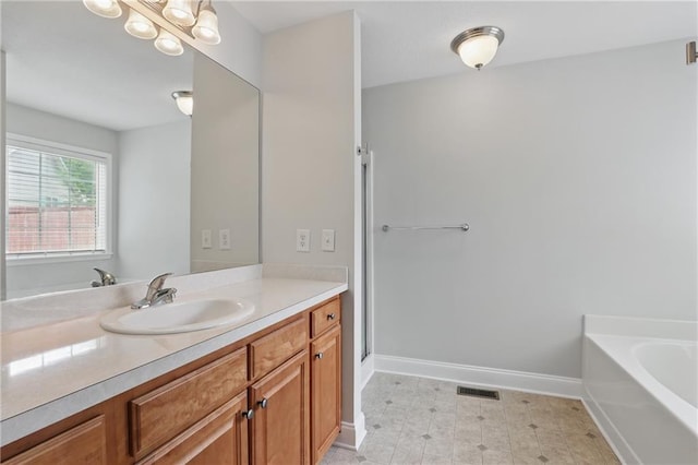199 Rocky Shoals Trl, Mount Airy, GA 30563 - full bath featuring vanity, a garden tub, baseboards, and a shower with door