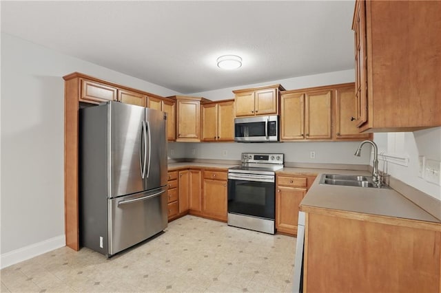 199 Rocky Shoals Trl, Mount Airy, GA 30563 - kitchen with stainless steel appliances, a sink, light floors, baseboards, and light countertops