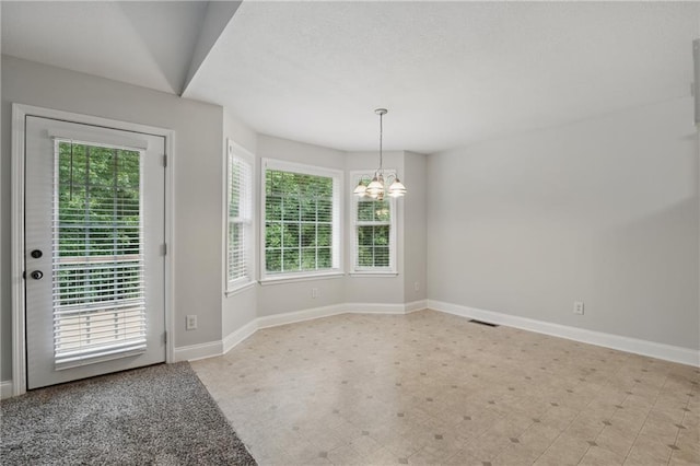 199 Rocky Shoals Trl, Mount Airy, GA 30563 - unfurnished dining area with a chandelier, baseboards, healthy amount of natural light, and light flooring