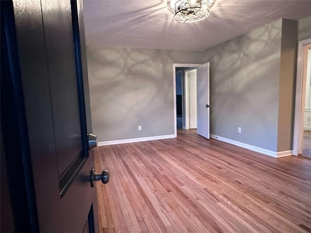 unfurnished bedroom with hardwood / wood-style flooring