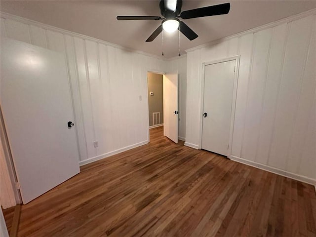 unfurnished bedroom with ceiling fan and dark hardwood / wood-style floors