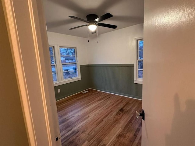 unfurnished room featuring hardwood / wood-style floors and ceiling fan