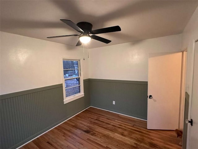 unfurnished room featuring dark hardwood / wood-style flooring and ceiling fan