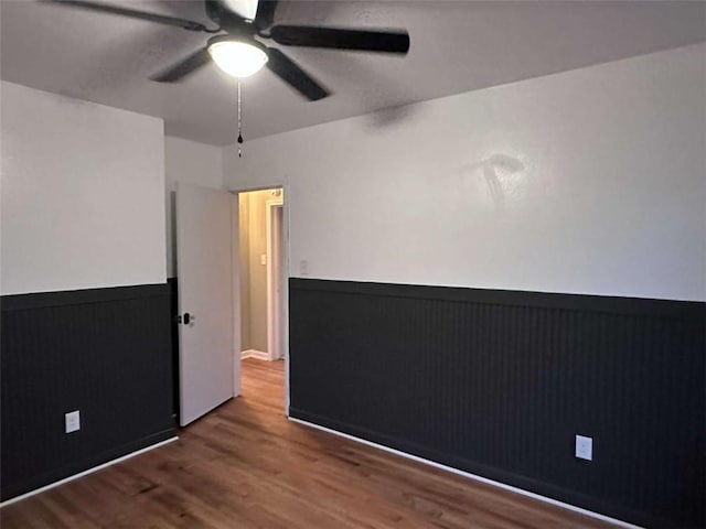 unfurnished room with ceiling fan and hardwood / wood-style floors