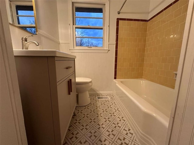 full bathroom with vanity, toilet, and tiled shower / bath