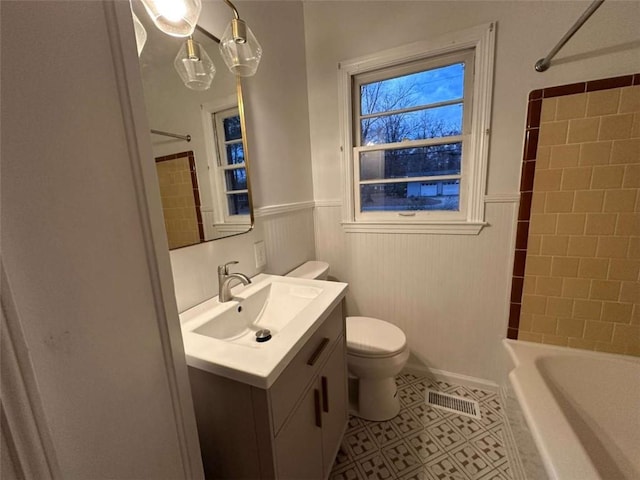 full bathroom featuring tile patterned flooring, vanity, toilet, and tiled shower / bath