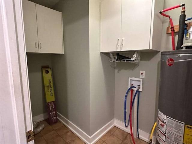 laundry area featuring tile patterned flooring, cabinets, hookup for a washing machine, and water heater