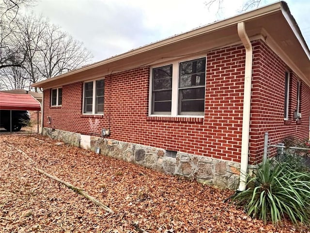 view of side of property featuring a carport