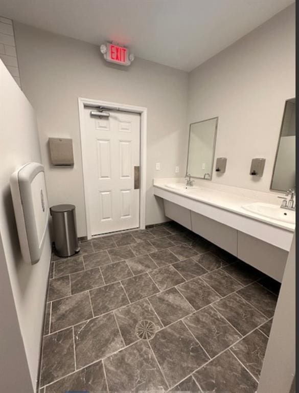 full bath with double vanity and a sink